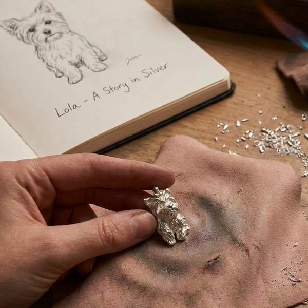 holding a silver crafted dog